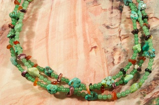 Beautiful 3 Strand Necklace featuring Genuine Jade. Genuine Turquoise, Spiny Oyster Shell and Amber Accents. Sterling Silver Cones and Clasp. Created by Santo Domingo Artist Carol Pacheco. The Santo Domingo Pueblo is in New Mexico, near Santa Fe. 